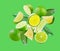 Set of perfectly retouched limes with leaves, whole halves and slices isolated on green background. Limes fly through space.