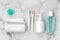 Set of pink and turquoise blue toothbrushes, toothpaste and other tools on marble background.