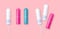 Set of pink and turquoise color tampons on rose background