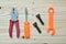 Set of plastic toy tools over wooden