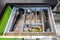 Set of plates, cups, knives, forks and wine glasses on the shelf in the kitchen cabinet