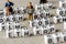 Set of popular crypto coins forming rows made of white cubes with black capital letters and miniature businessmen figurines having