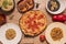 Set of popular dishes of basic Italian food with a diavola pizza, parmentier, arroz nero, pasta of various types