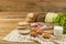 Set products consisting of bread, milk, pork, eggs , and vegetable on wooden table background