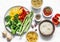 Set of products for vegetarian lunches - pasta, rice, bulgur and fresh vegetables on a light background, top view