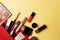 Set of professional elite decorative cosmetics for makeup on a yellow background. The concept of beauty and fashion.