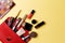 Set of professional elite decorative cosmetics for makeup on a yellow background. The concept of beauty and fashion