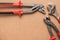 Set of pump plier, plier and wrenches. Tools over a wood panel.