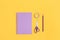 Set of purple stationery on a yellow background.