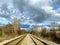 Set of railroad tracks distance cloudy