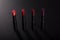 Set of red lipsticks on black background