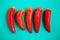 Set of red peppers on the turquois background