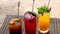 Set of Refreshing Fruit Cocktails Standing on Table on Beach near Turquoise Sea