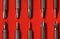 Set of replaceable screwdrivers on red background