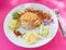 Set of rice with mas fried in batter on a white plate with slices of pineapple, onion, cucumber