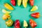 Set of ripe assorted bell peppers on a pastel green background