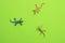 Set of rubber lizard toys on a green background