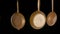 Set rustic copper fryingpans hanging on isolated black studio background. Round empty gold pans with handles