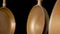 Set rustic copper fryingpans hanging on isolated black studio background. Round empty gold pans with handles