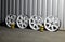 Set Of Rusty Damaged Alloy Wheel Rims In Garage