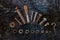 Set of rusty screws, nuts and small tools on a dark wooden background.