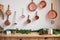 Set of saucepans hanging in kitchen. Hanging Copper kitchen utensil on the white wall. Different kind of vintage copper cookware,