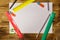 Set of school stationery supplies. Blank paper sheet, rulers, pencils, erasers and sharpener on wooden desk. Top view