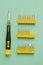 A set of screwdrivers for precision work on green background