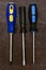 Set of screwdrivers three hand-held fixing tools home repairman on dark background design base