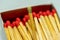 Set of several defocused red-headed matchsticks with one golden-headed matchstick in evidence.