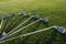 Set of shiny golf clubs arranged on grass