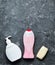 A set of shower products on a black concrete surface. Soap, shampoo, body gel. Copy space.