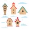 Set of simple bird houses with clouds on a white background. Vector child flat illustration of small homes