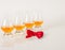 Set of single malt tasting glasses, single malt whisky in a glasses, white background, red bow