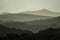 Set of sloping mountains without clouds with background with fogs and trees in backlight