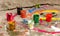 A set of small colorful used open paint containers laying on the ground. Kids children creativity, arts and crafts abstract