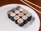Set of small sushi rolls on a white plate