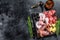 Set of smoked and dried meat Ham, jerky, salted meat, jamon and herbs. Black background. Top view. Copy space