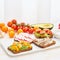 Set of smorrebrods with fish, anchovies, avocado, tomatoes, radish. Side view, copy space, white background