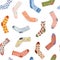 Set of socks on a white background seamless pattern. Print drawn with pencils on paper. Cozy autumn and winter illustration. New