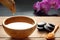 A set for spa procedures, hot massage stones, bath salts and flavored water collected from a bamboo stem into a bowl, orchid flowe