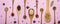 Set of spice mixes in wooden spoons on pink background. Top view  flat lay  banner