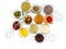 set of spices in glass jars on white background, top view. Paprika, curry, Bay leaf, anise and other seasonings