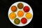 Set of spices and herbs on a white plate. Indian cuisine Pepper, salt, paprika, curry,mustard, nutmeg, turmeric. View from