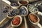 Set of spices in wooden spoons, closeup, top view. Various pepper, chili peppers, cardamom, carnation, star anise, paprika, and