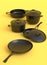 Set of stewpot, frying pan and chrome plated cookware on monochrome background