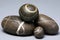 Set of striped rocks pebbles on grey background