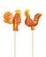 Set of sugar lollipop made in the shape of cockerels on a wooden stick