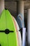 Set of surfboards of different colors in a pile.Surfboards on the sandy beach for rent. Surf lessons on the beach