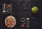 Set of sushi and rolls with teapot on black rustic wood, top view